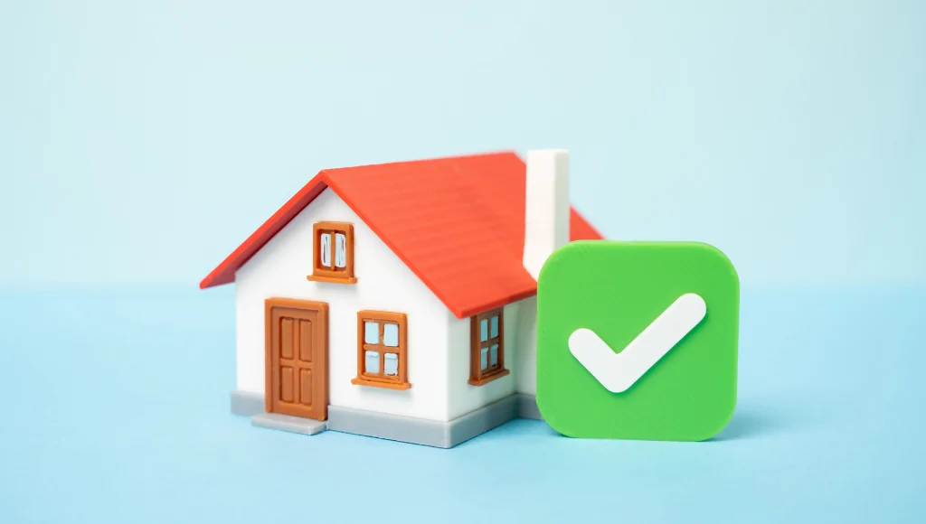 A model house on a blue background with a green checkmark beside it.