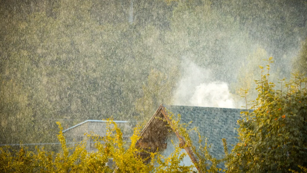 A spring rain storm over suburban houses.